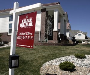 a-sale-sign-stands-as-a-sentry-outside-an-unsold-single-family-home-in-a-new-development-in-the-east-denver-suburb-of-aurora-colo-in-this-2007-file-photo