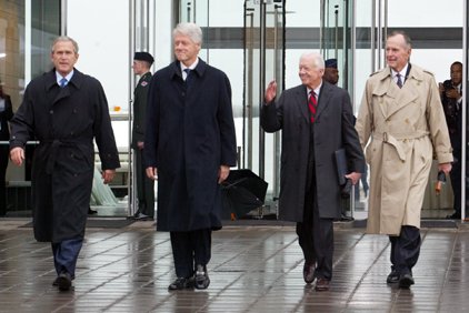 president-george-w-bush-former-presidents-bill-clinton-jimmy-carter-and-george-h-w-bush-walk-toward-the-speakers-platform-before-the-clinton-library-dedication-in-little-rock-in-this-2004-file-photo