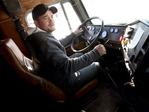 randy-mason-22-a-truck-driving-student-at-northwest-technical-institute-in-springdale-checks-his-mirrors-as-he-reverses-a-rig