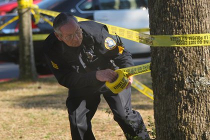 ualr-police-officer-sgt-james-heath-tapes-off-an-area-near-the-theater-building-on-campus-where-a-student-was-shot