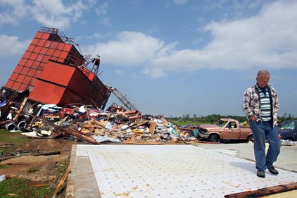 bobby-mcnew-surveys-damage-to-caldwell-feed-co-north-of-damascus-on-highway-65-after-a-tornado-friday-morning