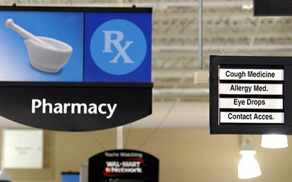 a-pharmacy-sign-hangs-in-the-wal-mart-supercenter-in-springdale-in-this-2005-file-photo