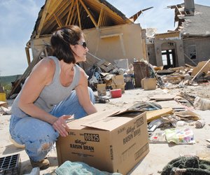 volunteer-shara-turk-boxes-up-what-remains-of-the-lee-familys-possessions-monday-in-the-emerald-isle-neighborhood-in-greers-ferry