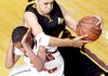 Grady Ricquan Jones (left) of the Arkansas Hawks tries to avoid fouling North Carolina Celtic Stars' Jordan Gaddy on Wednesday in the AAU national tournament at Little Rock. Scores, details on Page 3C.