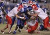 Bryant's Dijon Benton (middle) is brought down by Cabot players Jordan Carlisle (#11) and Michael James (#14)  in this 2007 file photo. 