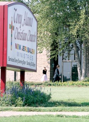 Members of the Tony Alamo Christian Church in Fort Smith enter the building for the 3 p.m. service Sunday. Alamo's compound in Fouke was raided by authorities Saturday evening.