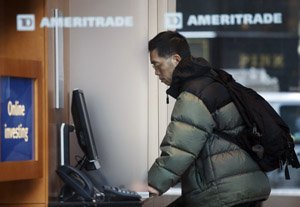 a-man-checks-stock-prices-online-at-a-td-ameritrade-brokerage-wednesday-in-new-york