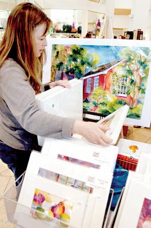 Marianne Kirksey from Conway checks out the watercolor painting by artist Delia Prather while Kirksey was shopping at the Arkansas Arts Center Museum School Sale in this 2007 file photo.