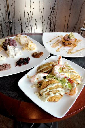 Tapas at Capi's include Fried Green Tomatoes & Shrimp Remoulade
(foreground), Artisan Cheese Sampler (upper left) and Tuna Tataki.