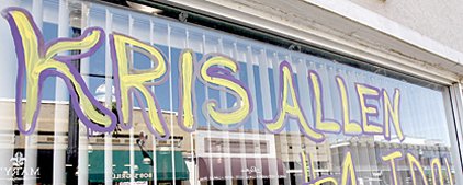 a-pedestrian-is-reflected-in-a-window-decorated-in-support-of-american-idol-finalist-kris-allen-on-oak-street-in-conway-on-monday