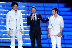 this-photo-provided-by-fox-shows-at-left-adam-lambert-and-kris-allen-right-with-host-ryan-seacrest-during-american-idol-on-wednesday-in-los-angeles