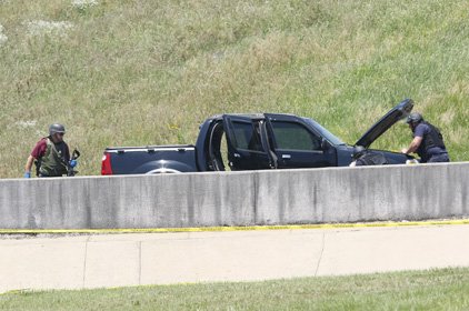 an-investigator-recovers-a-weapon-monday-from-a-vehicle-suspected-of-being-used-in-a-shooting-at-a-military-recruiting-office-monday