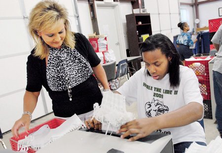 activity-director-renee-mcghee-left-watches-whitney-calvin-shred-some-documents-at-action-services-in-morrilton-the-business-which-employs-disabled-adults-plans-to-expand-the-workshop-and-its-programs