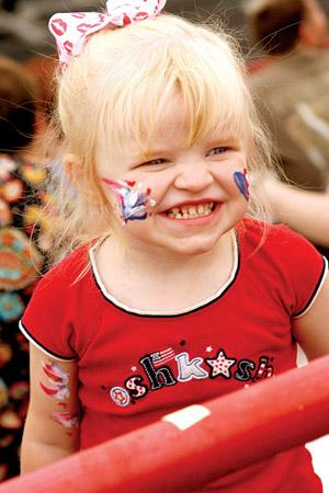 Amelia Jones of Jacksonville flashes a smile at people passing by at the 2008 Jacksonville Spectacular. The event, which will be held Friday at Jan Crow Stadium, will feature a fun zone for kids, local musicians performing and awards for community heroes.