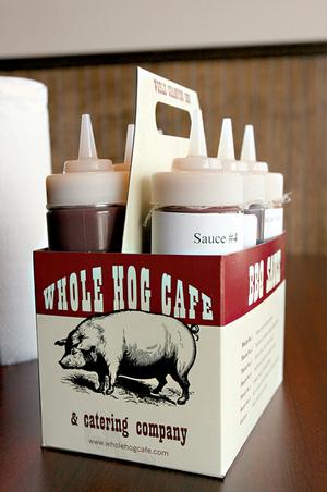 A six pack of sauces on tables allows diners customize their 'cue at
the new Markham Street location of Whole Hog Cafe.