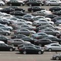 An employee (center) inspects Jaguar cars Monday outside an assembly plant in Birmingham, England. J...
