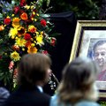 Visitors watch and listen Sunday during a memorial service outside of the Crescent Hotel & Spa in Eu...
