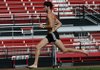 University of Arkansas track and field coach runner Dorian Ulrey runs across the infield Tuesday afternoon at John McDonnell Field in Fayetteville.