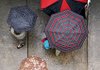People pour into the Center for Performing Arts at the University of Arkansas at Little Rock during a rainstorm Thursday. 