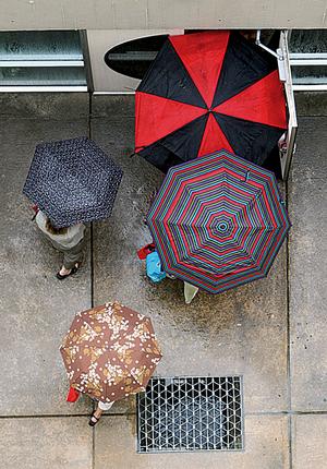 People pour into the Center for Performing Arts at the University of Arkansas at Little Rock during a rainstorm Thursday. 