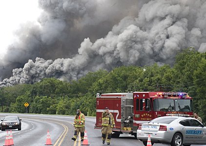 plumes-of-smoke-from-a-burning-chemical-plant-fill-the-sky-as-emergency-workers-form-a-roadblock-west-of-bryan-texas-thursday