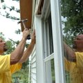 Walter Potapov works on windows on Edmond and Helen Cook's house near Fayetteville on Thursday as vo...