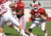 Arkansas sophomore tailback Broderick Green, center, carries the ball as freshman safety Chris Ragget (30) reaches to make the tackle during the Hogs' scrimmage Saturday April 4 at Razorback Stadium. 