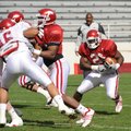 Arkansas sophomore tailback Broderick Green, center, carries the ball as freshman safety Chris Ragge...