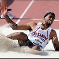 Arkansas junior Alain Bailey lands while competing in the long jump during the NCAA Outdoor Track an...