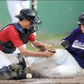 Bulldogs' Jacob Pinter, right, slides in at home as Columbia Angels White catcher Garrett Luce loses...