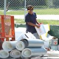 Roofing at Root:
A worker with Franklin and Sons Roofing and Sheet Metal Co. loads roofing material...