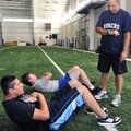 Rogers High School athletic trainer David Roller watched the clock while Cody Walker, back, 15, and ...