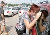 Chris and Kim Douglass look at a new Ford Escape on Monday at North Point Ford in North Little Rock. They said they were thinking about trading in their Honda Odyssey in the "cash for clunkers" program.