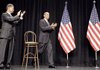 President Barack Obama, accompanied by Veterans Affairs Secretary Eric Shinseki, takes the stage during a rally Monday at George Mason University in Fairfax, Va.