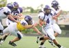 Fayetteville senior Michael Heintzman (4) carries the ball as junior lineman Kyle Hallam (61) blocks senior defender Chaz Williams during the Bulldogs' Spring Purple-White game May 22 at Harmon Field. 

