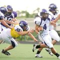 Fayetteville senior Michael Heintzman (4) carries the ball as junior lineman Kyle Hallam (61) blocks...