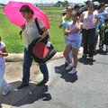 Guadalupe Rios, 5, of Rogers, left, and Maria Gonzalez waited in line Monday to receive free backpac...