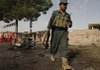 An Afghan police officer inspects near the scene of an explosion in Herat, west of Afghanistan's capital, Kabul, on Monday.