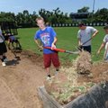 <b>Field work</b>
Fayetteville High School incoming sophomore baseball player Nick Gibson loads sod...