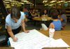 Third-grade teacher Sara Alderson writes down ideas as teachers from Asbell and Happy Hollow elementary schools brainstorm about team time teaching Monday at Happy Hollow Elementary School. Both schools have a continuous learning schedule, and their classes start Thursday. 