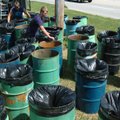 St. Joseph's Parish members Cody Davis, right, and Eric Pearce volunteer their time Monday afternoon...