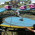 Willie Austin, from left, Randy Williams and Alfreado put together the tilt-a-whirl ride at the 111t...
