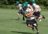 Greenland receiver Adrian Rojas runs after making a catch Tuesday in Greenland during practice.