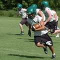 Greenland receiver Adrian Rojas runs after making a catch Tuesday in Greenland during practice.
