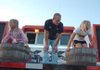 Charlotte McWhorter, 7, left, and Mary Stewart Beard, 8, stomp grapes as Matt Smith observes during the 111th Tontitown Grape Festival Tuesday at St. Joseph Catholic Church in Tontitown. The festival continues nightly through Saturday. 