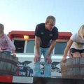 Charlotte McWhorter, 7, left, and Mary Stewart Beard, 8, stomp grapes as Matt Smith observes during ...