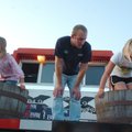 Charlotte McWhorter, 7, left, and Mary Stewart Beard, 8, stomp grapes as Matt Smith observes during ...