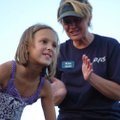 Olivia Castleman, 8, stomps grapes a tub of grapes as Kim Umber cheers her on during the Grape Stop ...