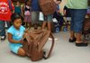 Mothlynn Latdrik, 6, looks through a backpack she received at the Samaritan Community Center on Wednesday in Springdale. The United Way of Northwest Arkansas and Samaritan Community Center are working together to provide more than 1,800 children with backpacks filled with supplies for school.