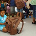 Mothlynn Latdrik, 6, looks through a backpack she received at the Samaritan Community Center on Wedn...